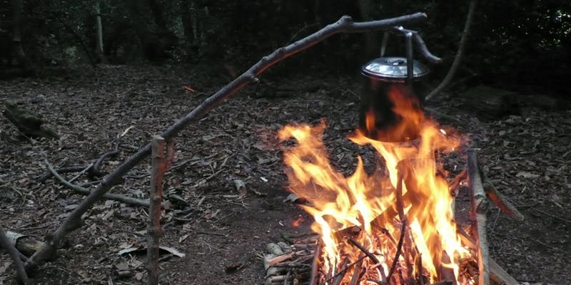 pot on open fire inside a tent - bushcraft with mountainwise